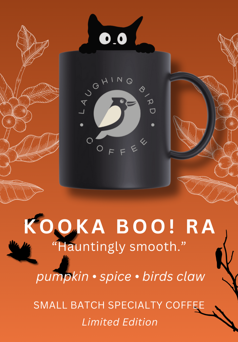 Black mug with 'Laughing Bird Coffee' logo on an orange background with Halloween-themed design.
